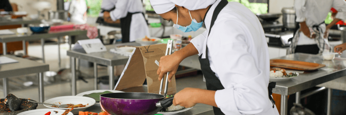 Food Safety Image of Woman Cooking in Industrial Kitchen